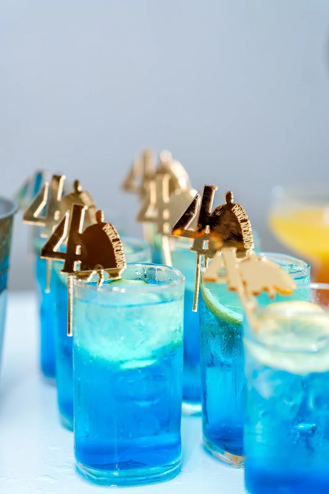 Blue lagoon cocktails lined up on the bar