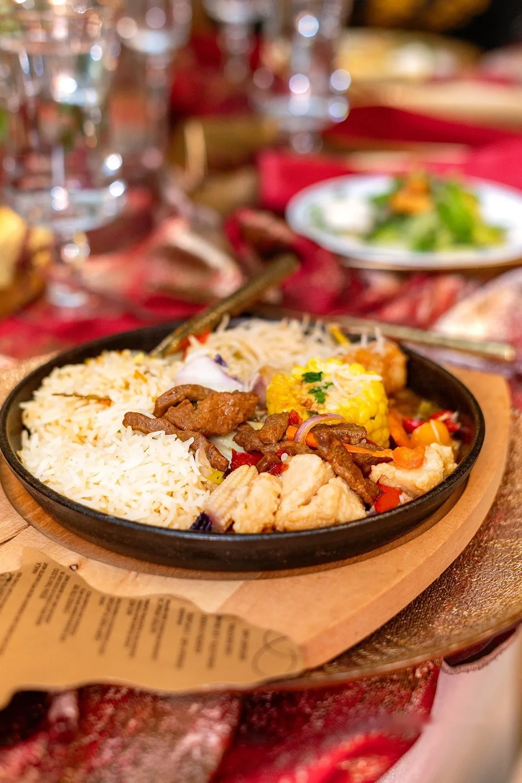 Jollof rice platter with grilled chicken, corn and plantain