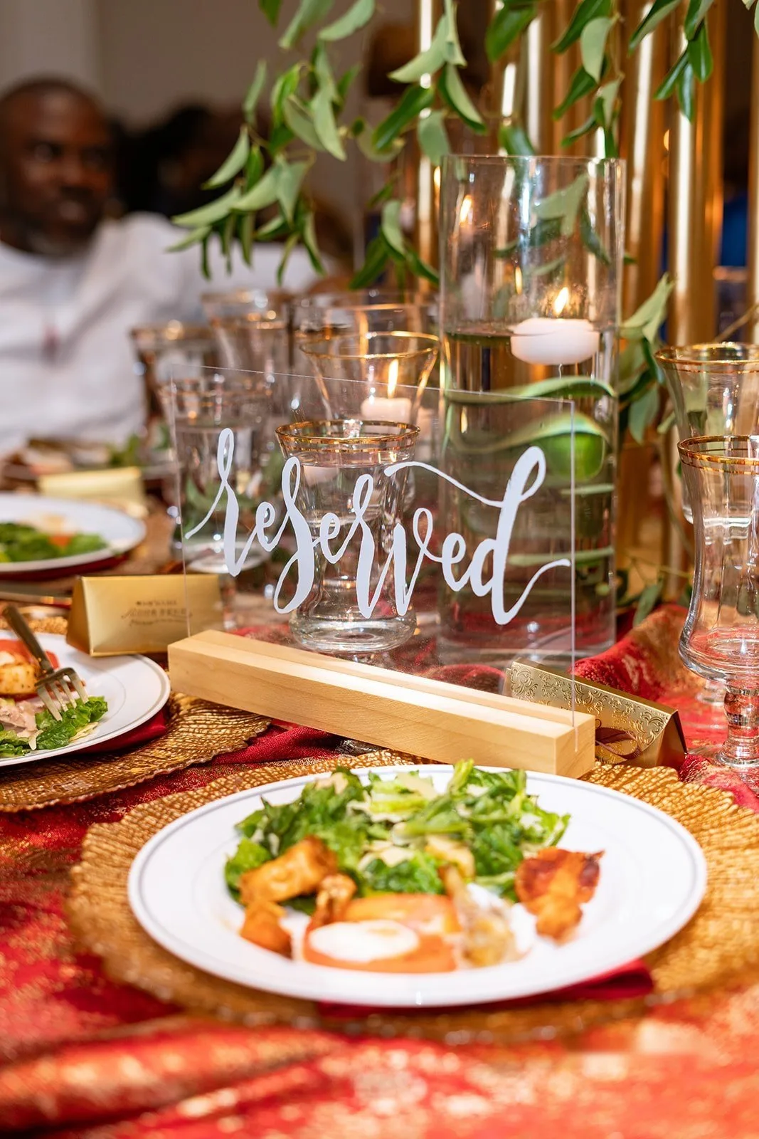 Reserved sign on a place setting with a plated salad